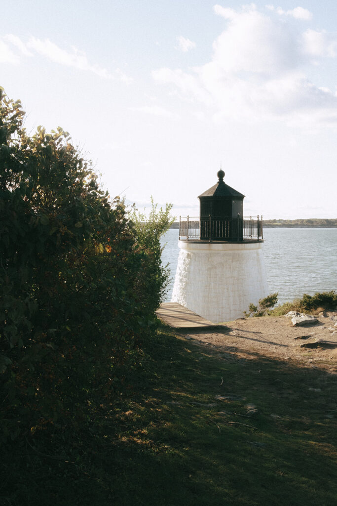 Castle Hill Lighthouse with Narragansett Bay in the background.