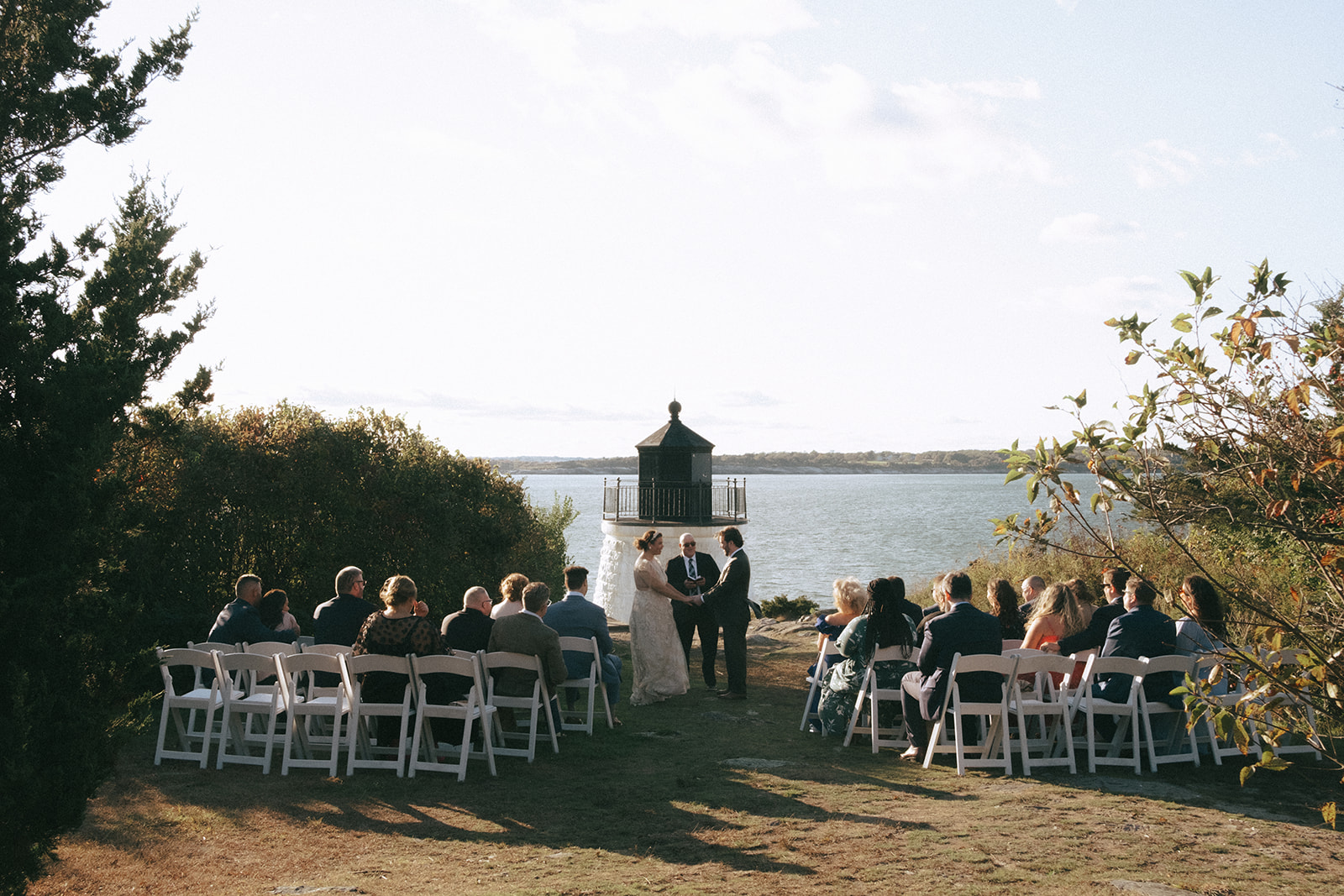 Castle Hill Inn wedding ceremony at the lighthouse. Fall wedding in Newport RI. Ceremony set up on the lawn by the lighthouse overlooking Narragansett Bay.