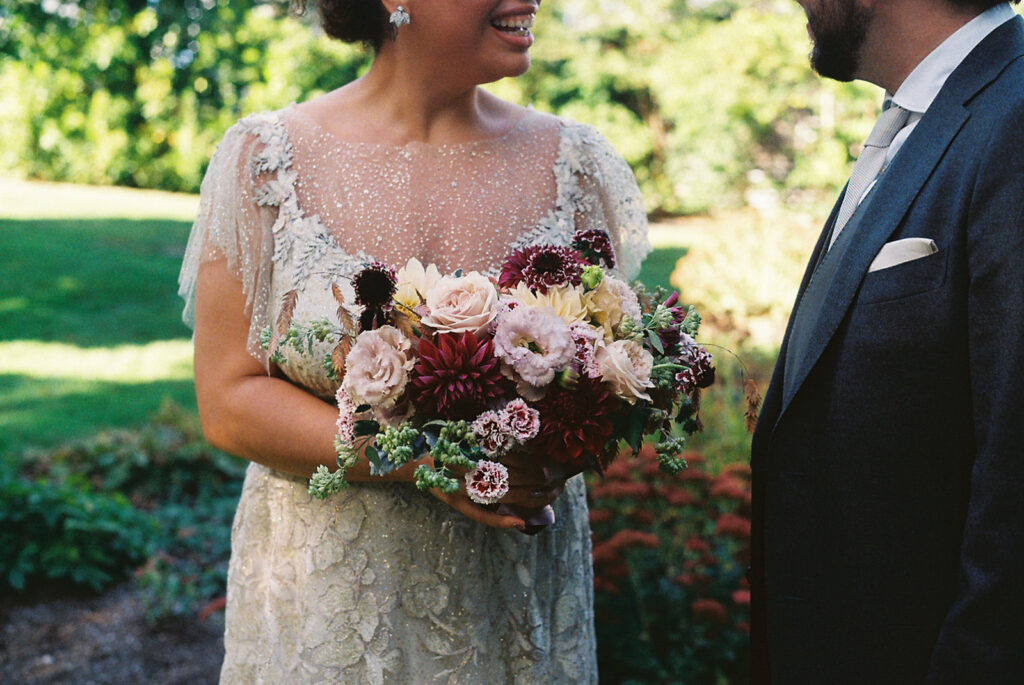 Close up of bride's bouquet of burgundy and blush tones. Photo by Rhode Tripper Photography