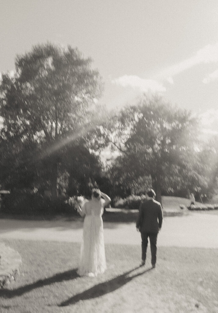 Black and white motion blur of bride and groom walking towards the chalet lawn at Castle Hill Inn. Photo by Rhode Tripper Photography