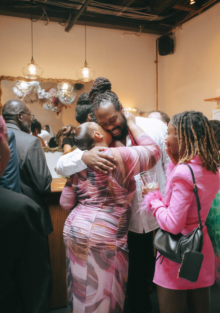 Groom hugs his family after his ceremony at Dearly Studio.