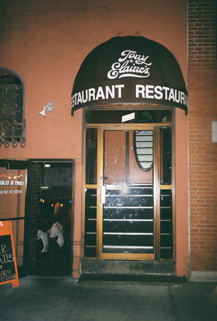 Exterior photo of Tony and Elaine's Boston showing the main entrance with a black awning and a side entrance to the wedding reception room.