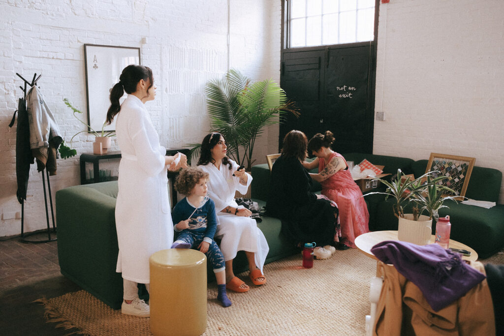 Bride's family and nephews watching TV in loft before ceremony. Photo by Rhode Tripper Photography