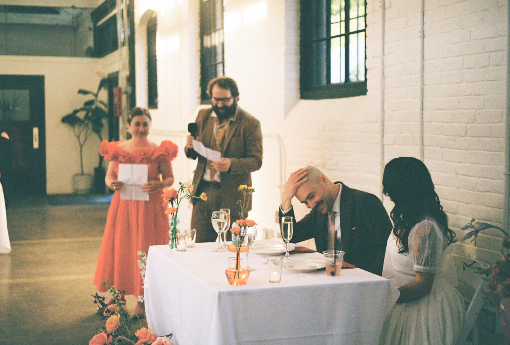 Close friends giving toasts at boutique hotel wedding reception in Providence. Photo by Rhode Tripper Photography