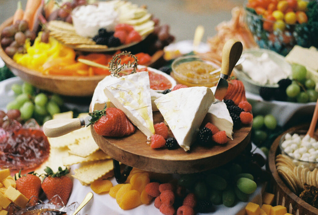 Epic grazing table with appetizers at wedding cocktail hour. Photo by Rhode Tripper Photography