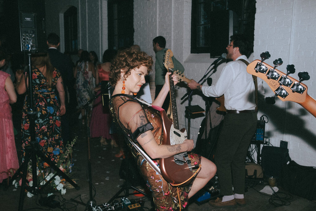 Friends performing as live band at boutique hotel spring wedding. Photo by Rhode Tripper Photography