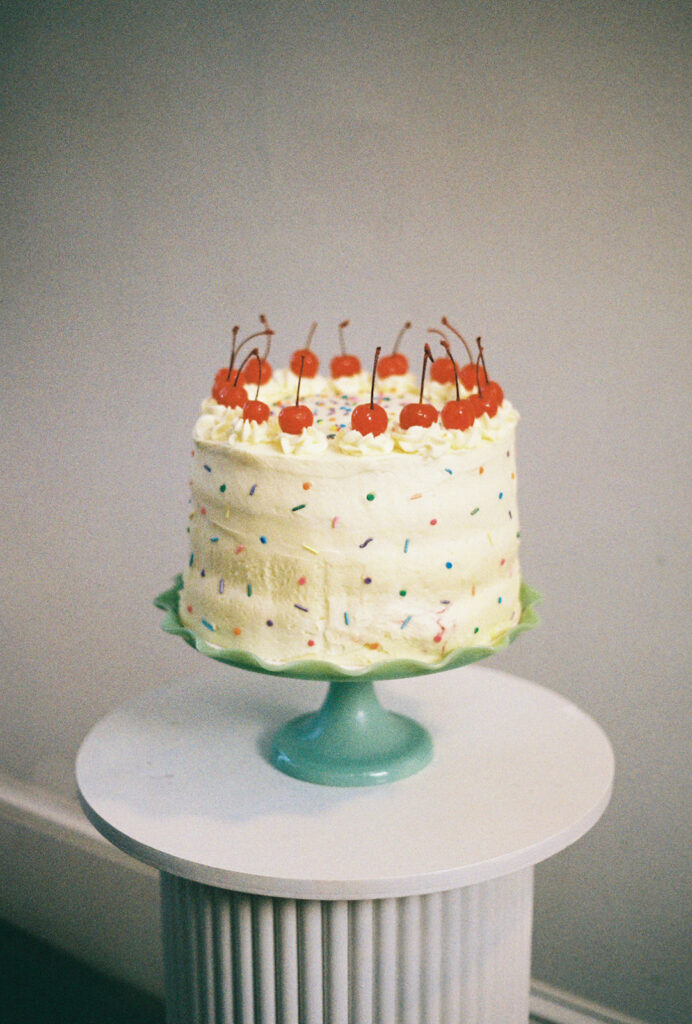 Colorful retro inspired cake at spring wedding reception at boutique hotel. Photo by Rhode Tripper Photography