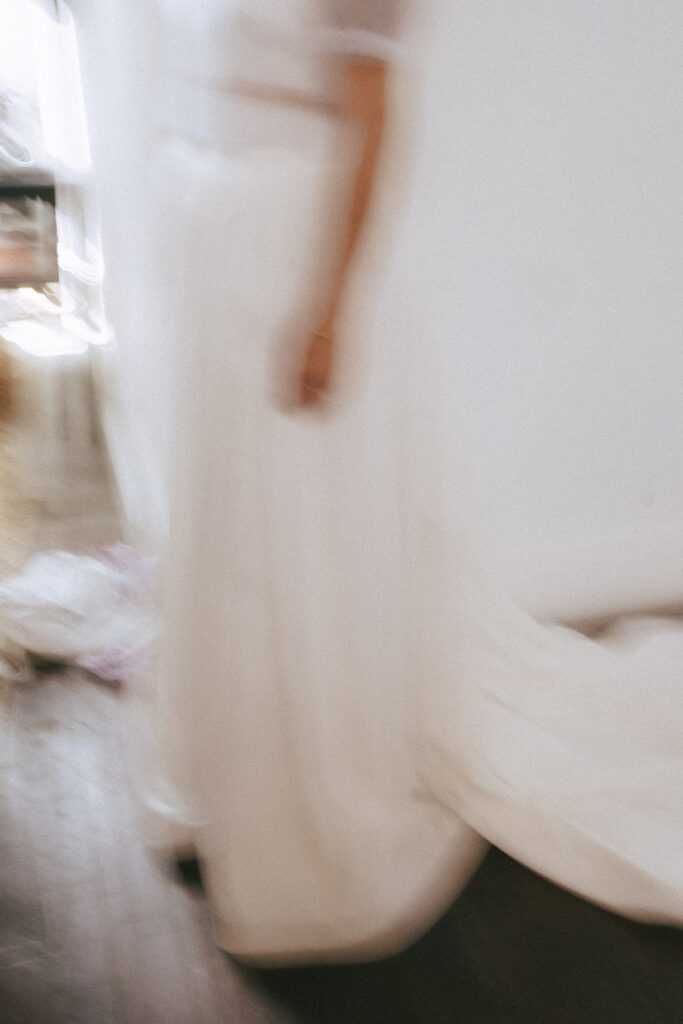 Artfully blurry photo of bride showing off her dress inside a boutique hotel in Providence. Photo by Rhode Tripper Photography