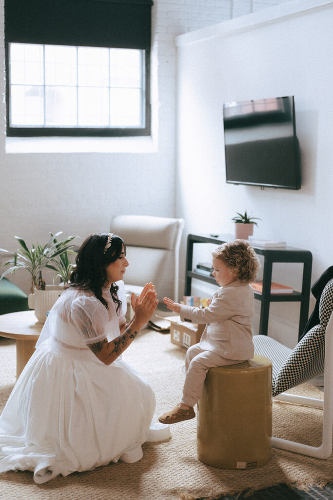 Bride spending time with her nephew in the loft space before the wedding ceremony begins. Photo by Rhode Tripper Photography