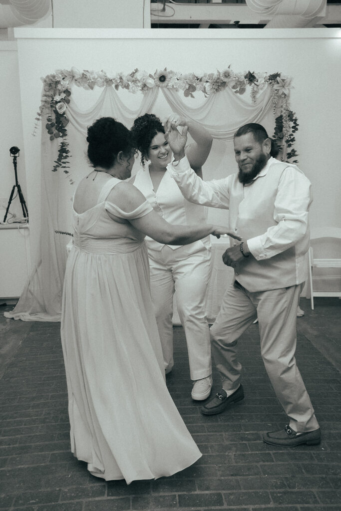 Marrier dancing with their parents during a special family dance.