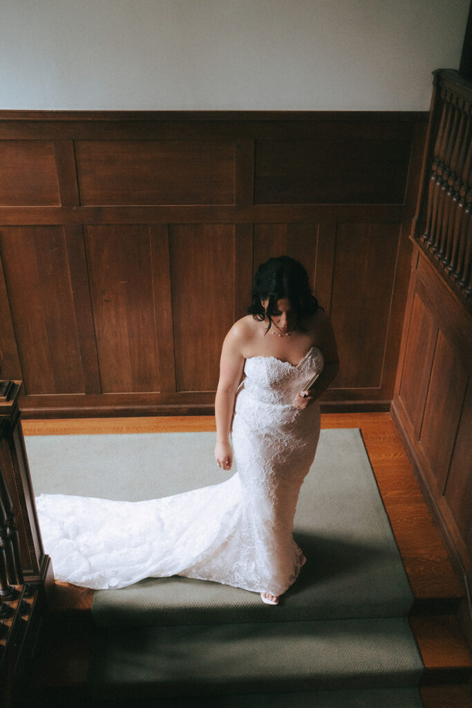 Bride walking down the stairs of Bradley Estate on her wedding day.