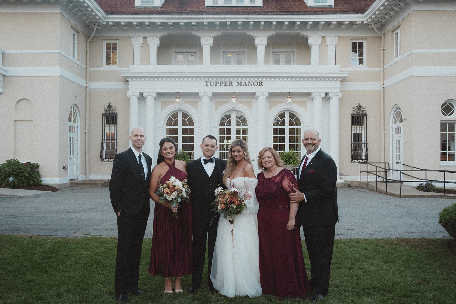 Formal family wedding photo in front of Tupper Manor.